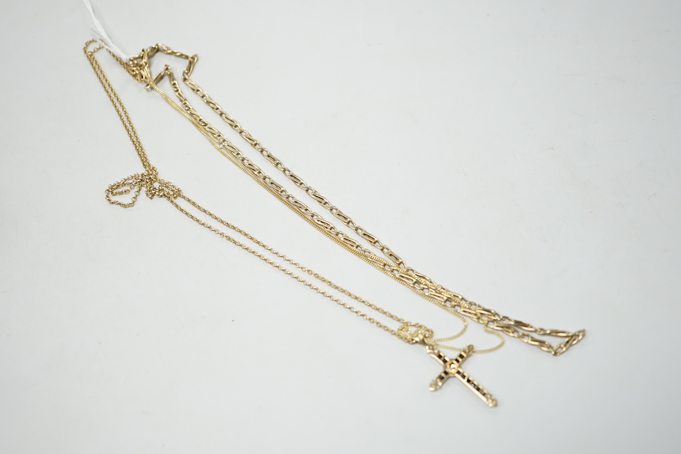 A modern 9ct gold, sapphire and diamond cluster set cross pendant, 33mm, on a 9ct gold chain and two other 9ct gold chains, gross weight 17.5 grams.